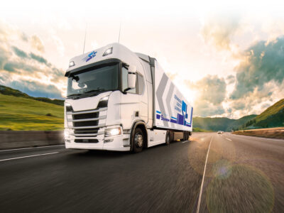 Truck with container on highway, cargo transportation concept. Shaving effect.