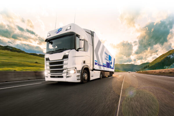 Truck with container on highway, cargo transportation concept. Shaving effect.